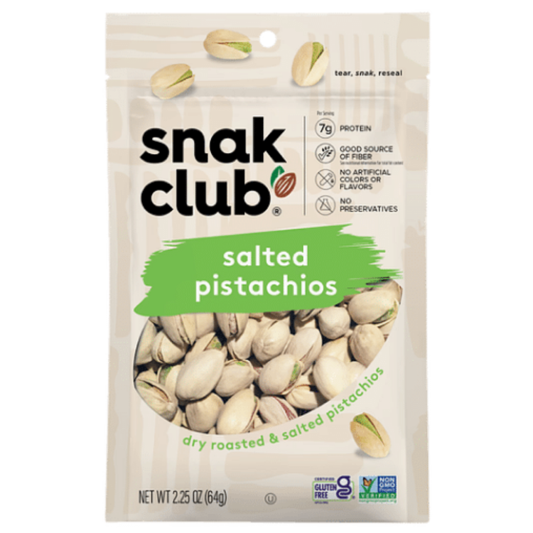 Salted pistachios in a 2.25oz Snack Club packet, premium snack by La Comprita, shown in a clear open bag with pistachios inside.