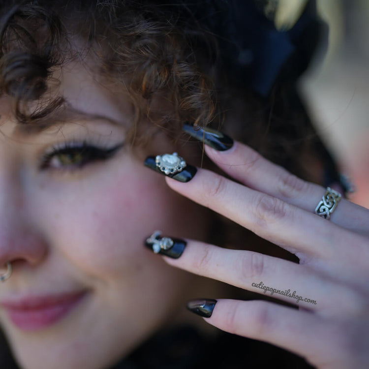 Black butterfly design press-on nails by Cutie Pop Nail Shop featuring a sleek black finish with butterfly accents.