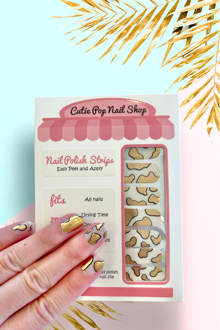 Guernsey Gold nail strips by Cutie Pop Nail Shop with shiny gold finish and intricate design, perfect for stylish manicures.