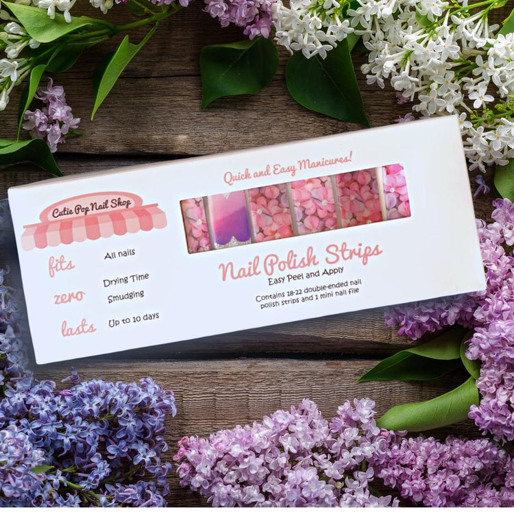 Pink flower and purple hue nail strips from Cutie Pop Nail Shop featuring floral design for stylish manicures.