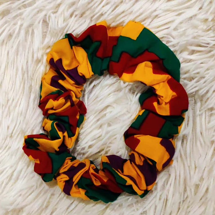 Red African print hair scrunchies by Duma Mbili LLC, soft fabric hair accessories for styling and securing hair.