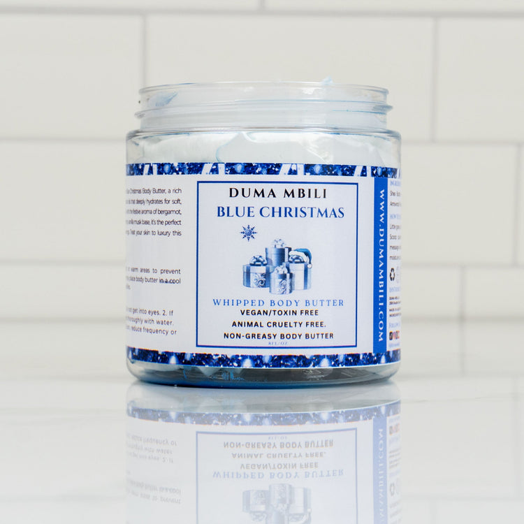Blue Christmas whipped body butter from Duma Mbili LLC, creamy and fluffy in a jar with festive holiday packaging.