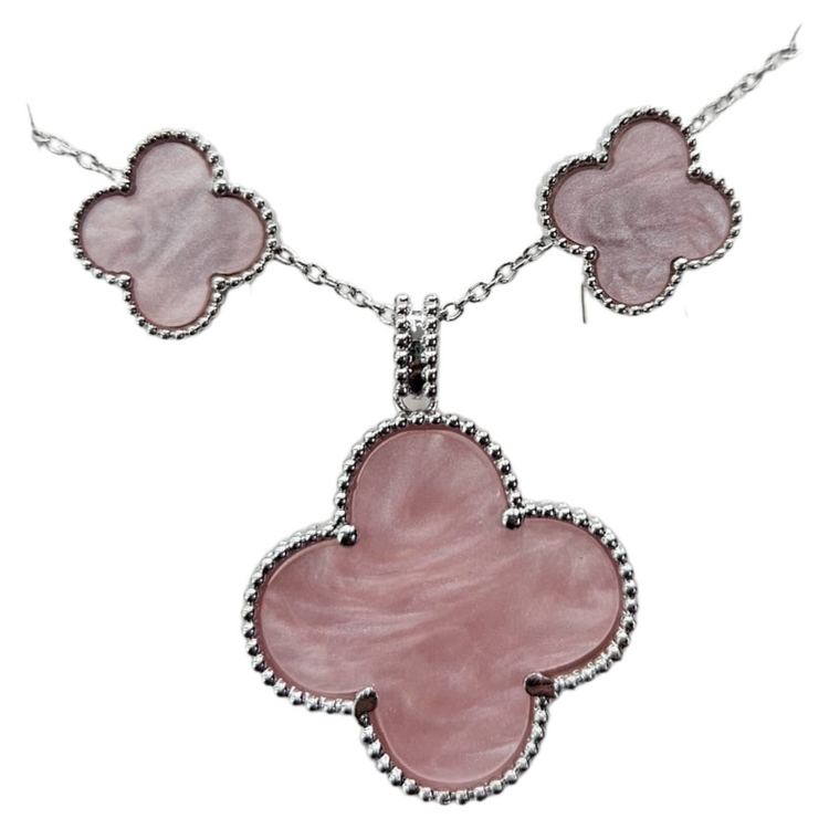 Valentina pink clover enamel jewelry set with matching necklace and earrings by Farmacias Savia, featuring vibrant pink and green clover designs.