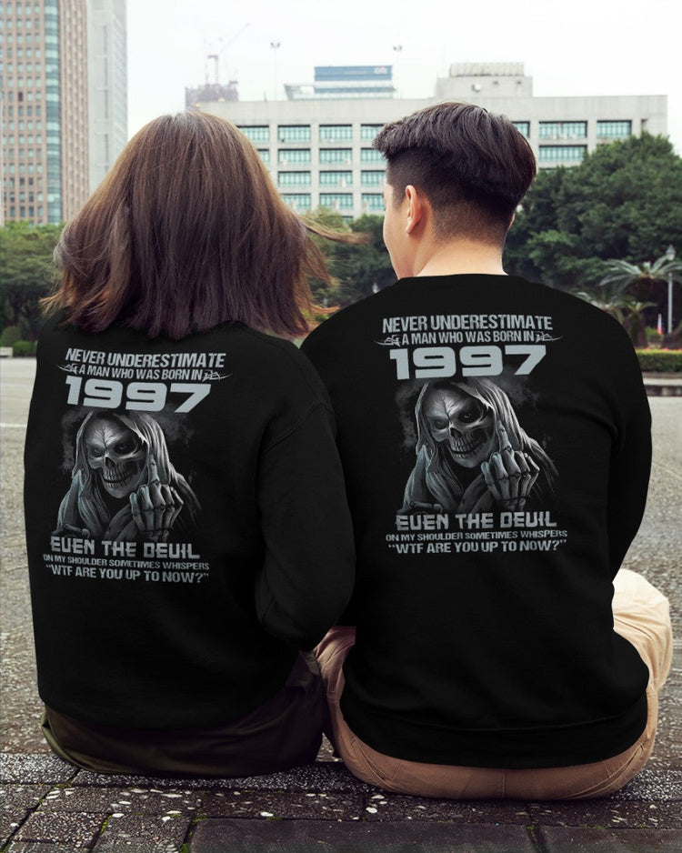Black T-shirt from TEELUVS.COM with "Never Underestimate Us 1997" printed front, casual fit, soft cotton fabric.