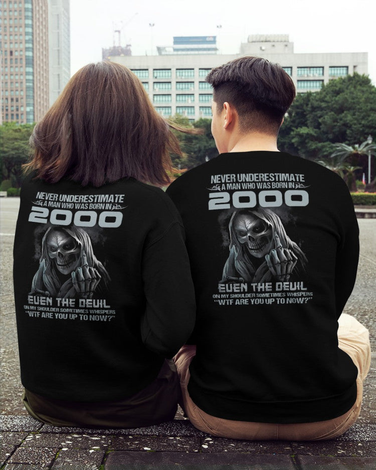 Black T-shirt for men with "Never Underestimate US2000" print, from TEELUVS.COM, displayed on a male model.