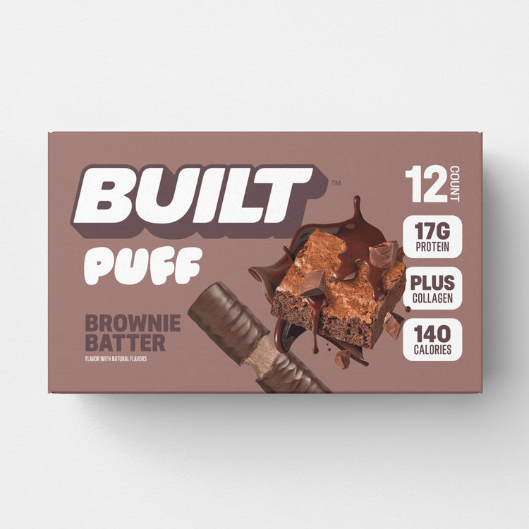 Built Brownie Batter Puff snack bar with chocolate flavor, displayed in a carton, showcasing the fluffy, brownie-inspired puff texture.