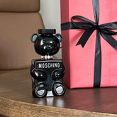 Moschino Toy Boy Eau de Parfum for Men bottle with playful design, 3.4oz size, displayed on a plain background.