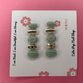 Green and gold sparkle press on nails from Cutie Pop Nail Shop, showcasing shiny, glamorous nail design with glitter accents.