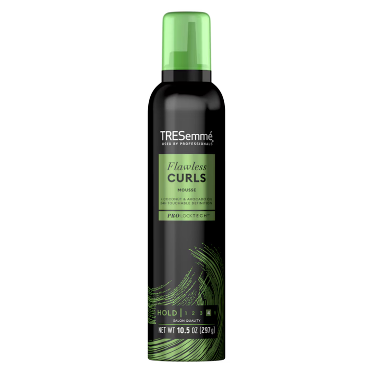 TRESemmé Flawless Curls mousse in 10.5 oz bottle, designed for enhancing natural curly hair, shown in the image.