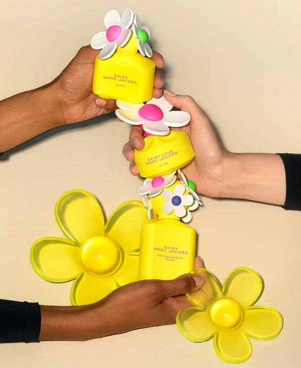 Marc Jacobs Daisy Love Glow Eau de Toilette spray for women, 1.7 fl oz, with the bottle and floral packaging visible.
