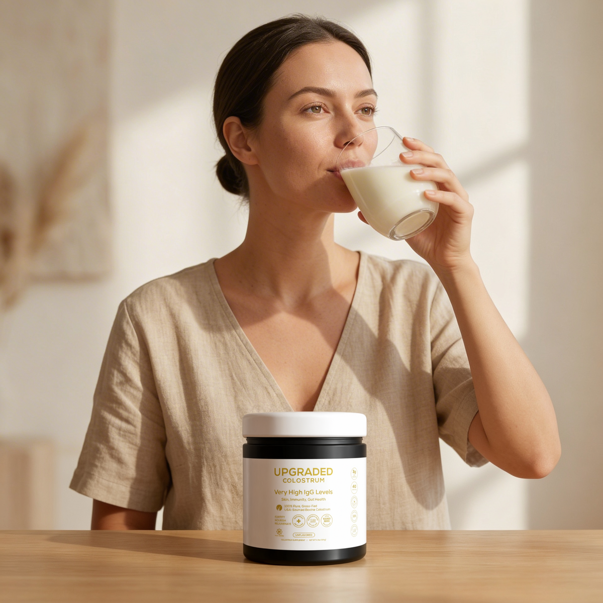Upgraded Formulas® upgraded colostrum supplement bottle with capsules, displayed on a lifestyle background with natural light.