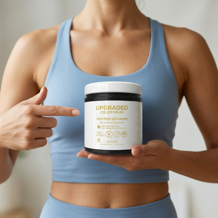 Upgraded Formulas® upgraded colostrum supplement bottle with label, placed on a white surface with a blurred lifestyle background.