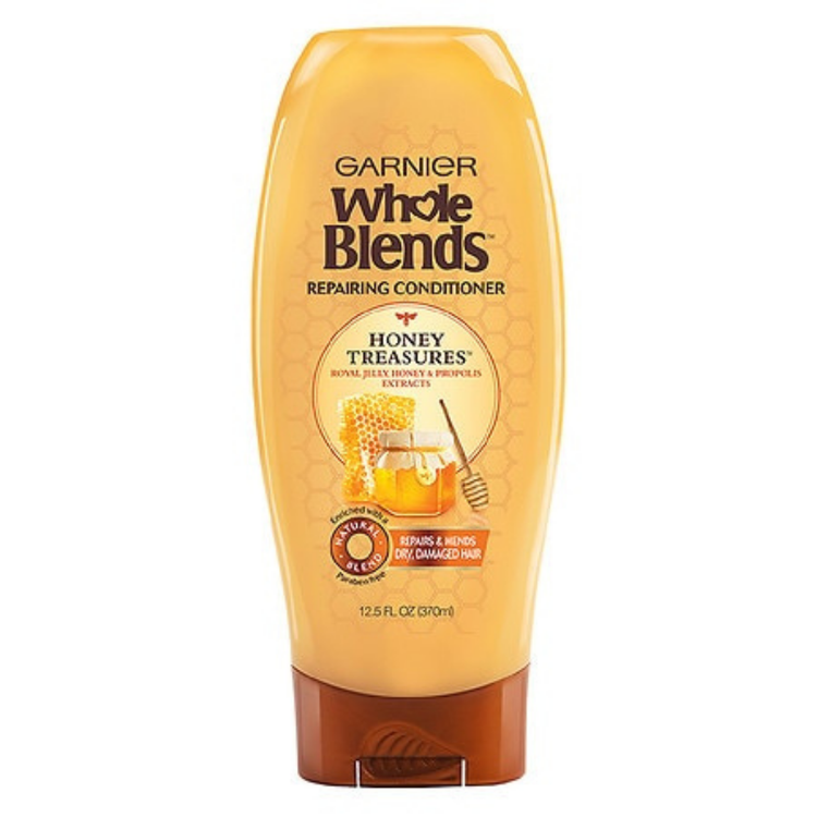 Garnier Whole Blends Repairing Conditioner Honey Treasures 12.5oz bottle with golden honey-themed packaging and label.