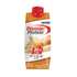 Premier Protein Caramel Shake in 11oz bottle, creamy caramel flavor, from Farmacias Savia, displayed in a candy shop setting.