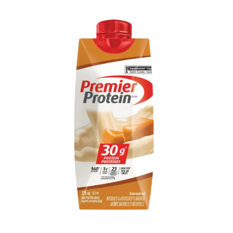 Premier Protein Caramel Shake in 11oz bottle, creamy caramel flavor, from Farmacias Savia, displayed in a candy shop setting.