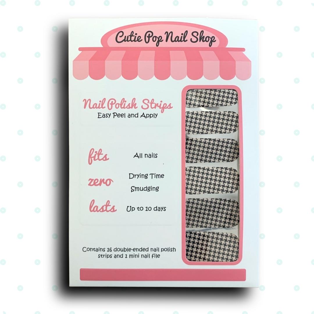 Houndstooth nail strips by Cutie Pop Nail Shop displayed on a hand, showcasing stylish black and white nail art design.