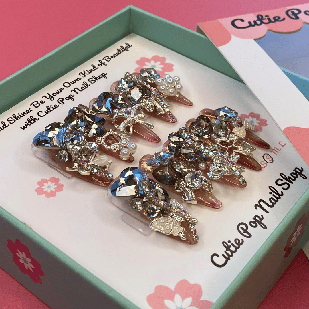 Cutie Pop Nail Shop Bougie Bling 14 press-on nails with sparkling rhinestone design on a clear acrylic base.