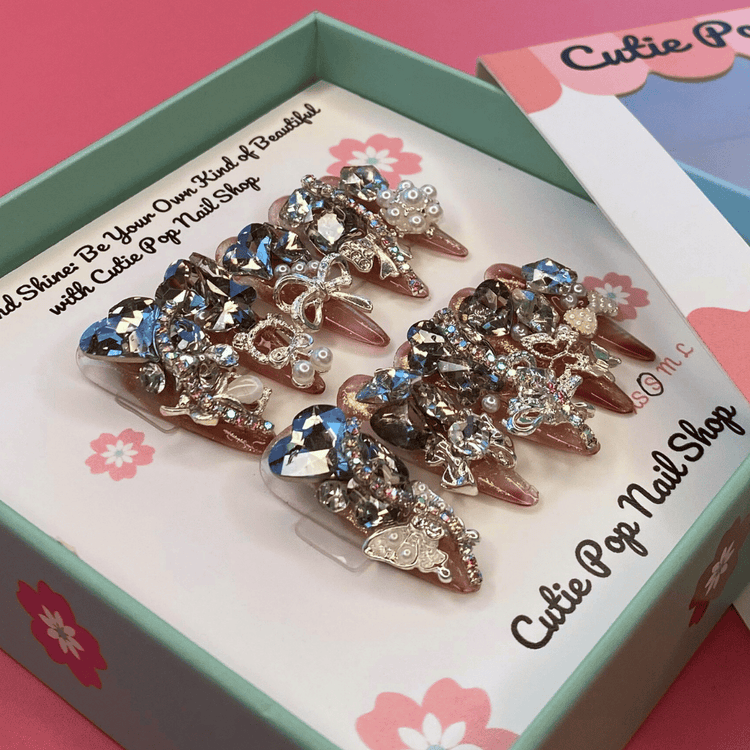 Cutie Pop Nail Shop Bougie Bling 14 press-on nails with sparkling rhinestone design on a clear acrylic base.