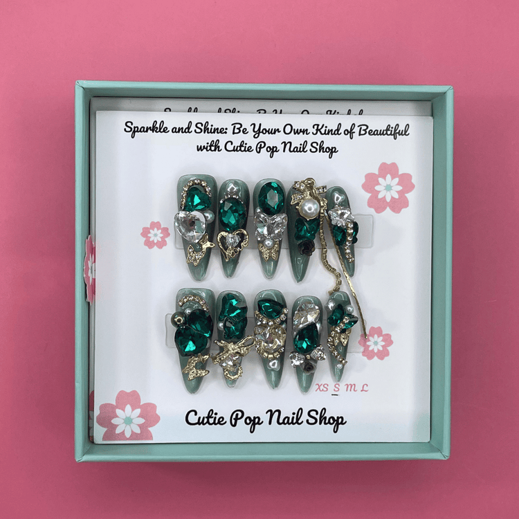 Press-on nails with shiny rhinestone accents from Cutie Pop Nail Shop&