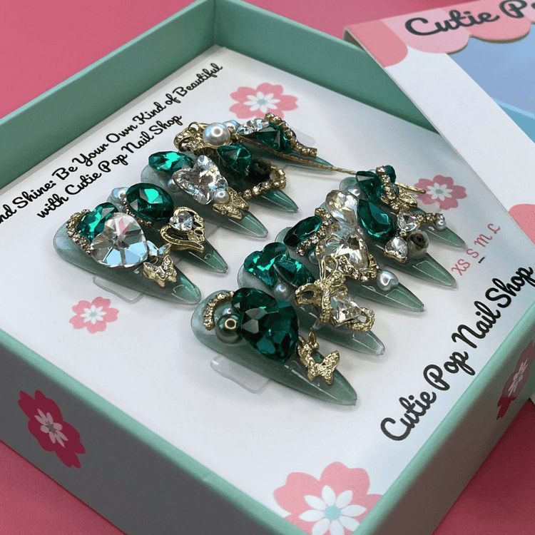 Press-on nails with a glittery, bling design from Cutie Pop Nail Shop&