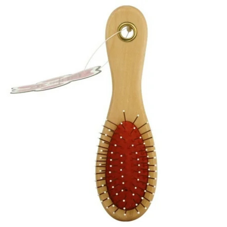 Farmacias Savia Happy Pet Pin Brush with metal pins for grooming pets, shown on a clean surface.