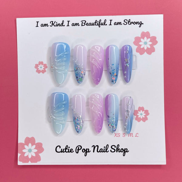 Set of Enchanted Ombre press-on nails by Cutie Pop Nail Shop featuring pastel gradient nail tips on a white background