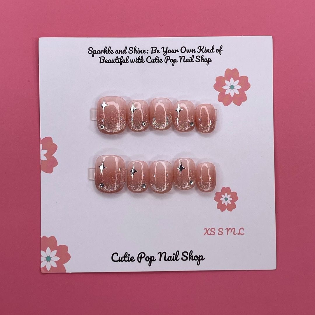 Glittery blush pink press-on nails from Cutie Pop Nail Shop with a sparkling finish and elegant design.