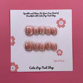 Glittery blush pink press-on nails from Cutie Pop Nail Shop with a sparkling finish and elegant design.