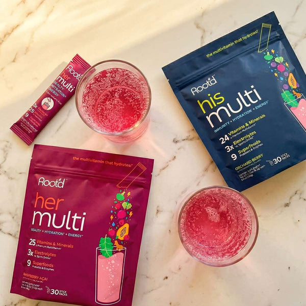 Couples' wellness pack with Root'd hydrating multivitamins for her and him, featuring his and hers vitamin bottles side by side.