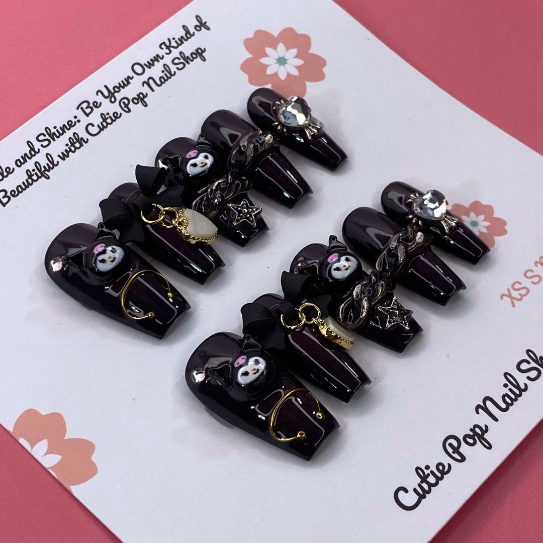 Black and white Kuromicore press-on nails with intricate design, from Cutie Pop Nail Shop, displayed on a white background.