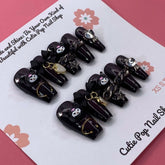 Black and white Kuromicore press-on nails with intricate design, from Cutie Pop Nail Shop, displayed on a white background.