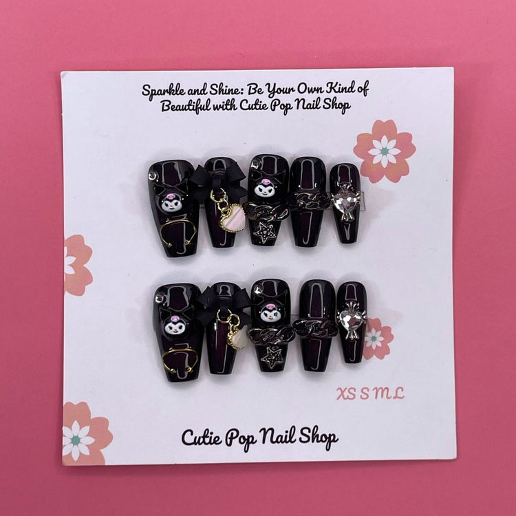 Black and white Kuromicore press-on nails by Cutie Pop Nail Shop displayed on a white background.