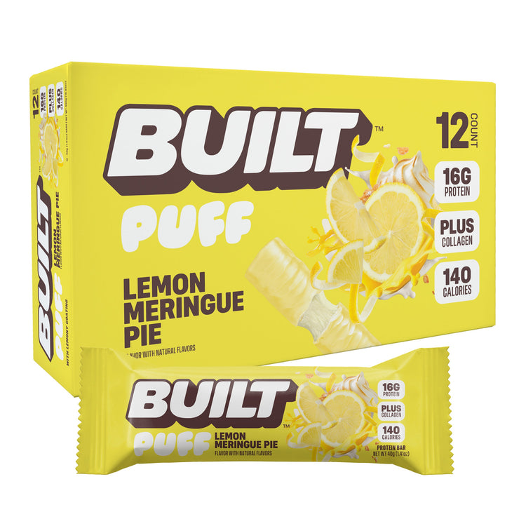Stack of BUILT Lemon Meringue Pie Puff snacks in a silo box wrapper, showcasing crispy puff pastries with lemon filling and meringue topping.