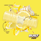 Stack of lemon meringue pie flavored puffs by BUILT, showcasing golden, flaky pastry with lemon cream and meringue topping.
