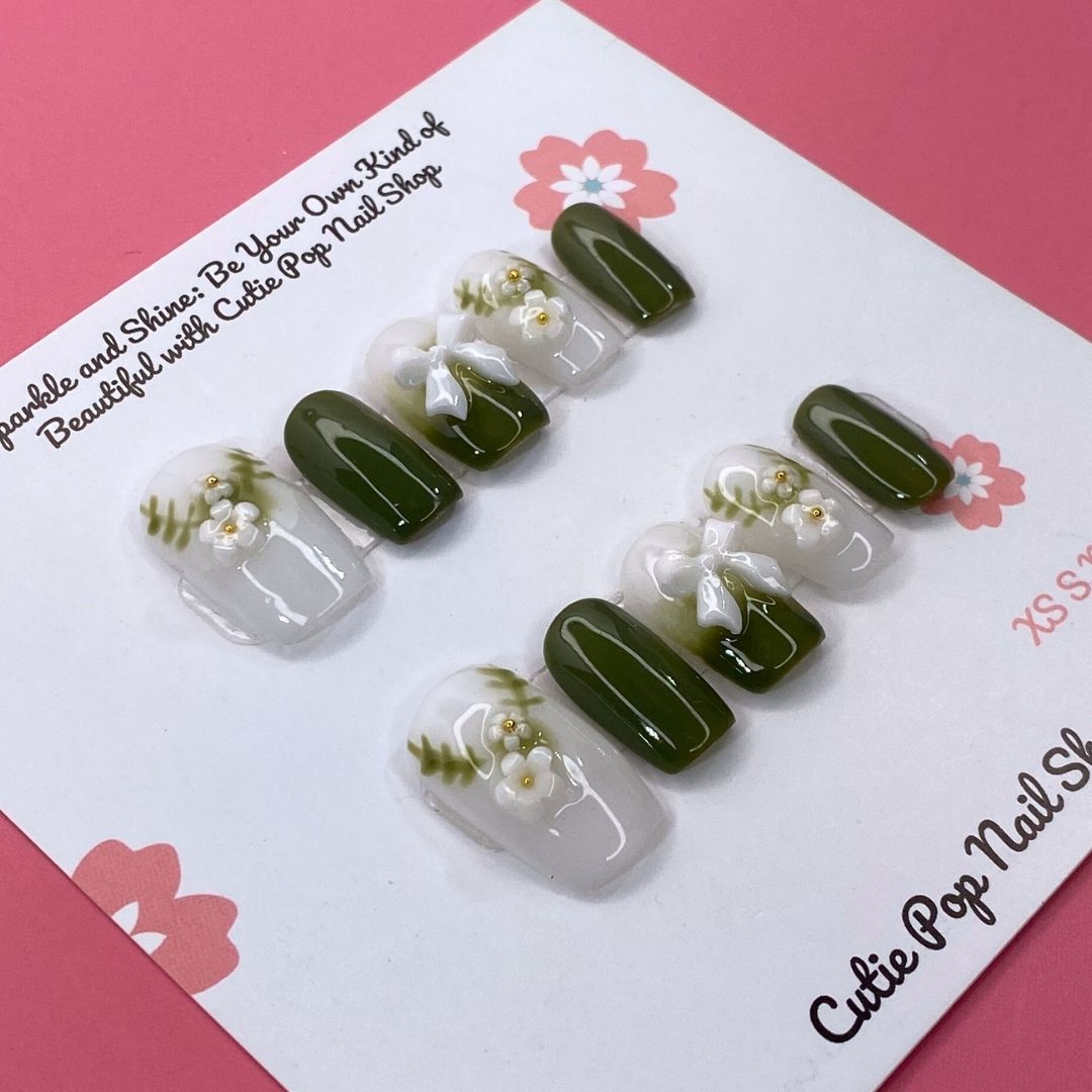 Press-on nails in a lovely olive green color by Cutie Pop Nail Shop, showcasing a sleek, natural-looking nail design.