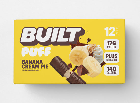 Stack of BUILT Banana Cream Pie Puffs arranged on a tray, showing the creamy banana filling inside the pastry.