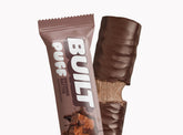 Built Brownie Batter Puff, a chocolate-flavored protein snack with a soft puff texture, stacked and ready to enjoy.