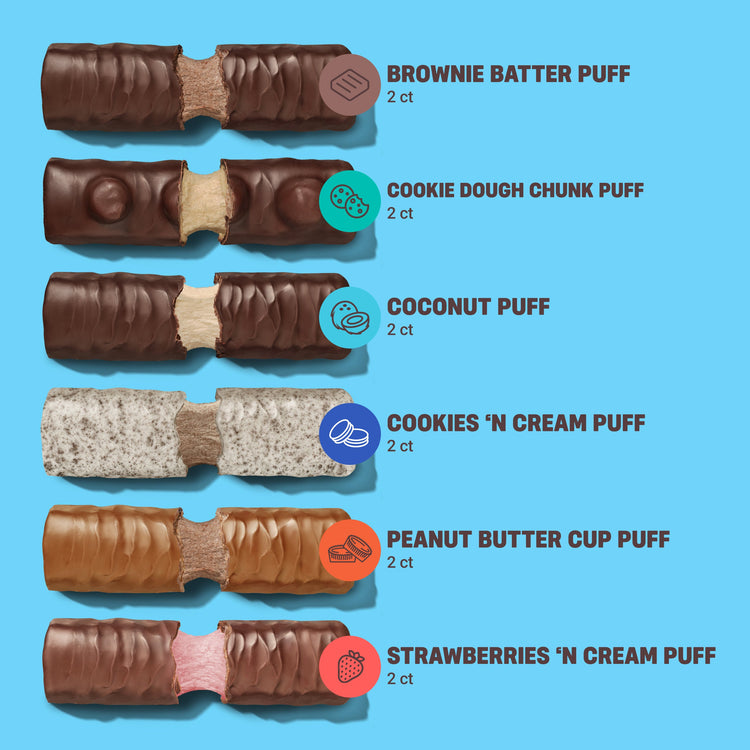 Stack of BUILT 12-pack mixed flavor snack boxes featuring a variety of global puff snack flavors.
