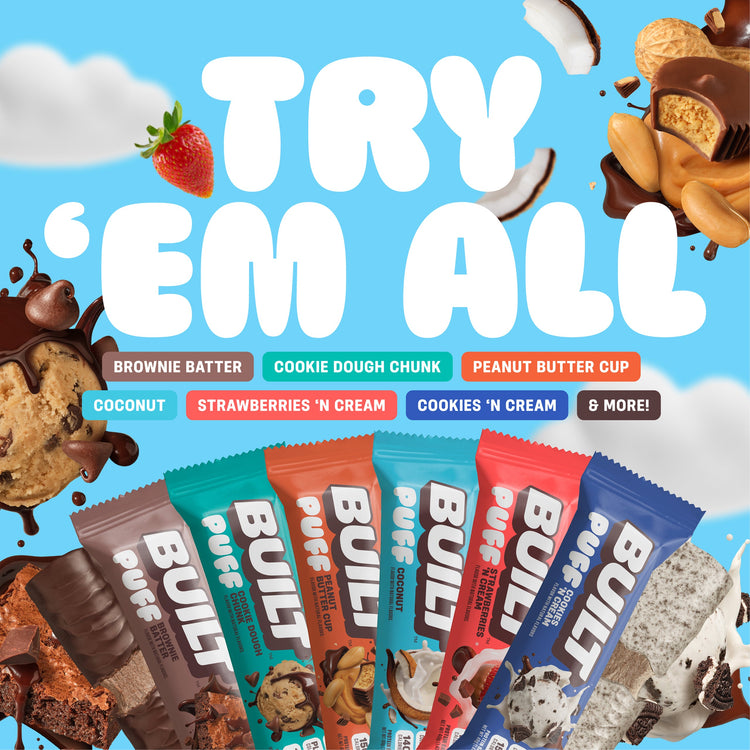 Stack of BUILT 12-pack mixed snack boxes with assorted puff snacks in colorful packaging.