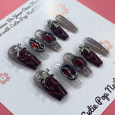 Rebel Chic press-on nails by Cutie Pop Nail Shop showcasing stylish, bold nail art on natural-looking nail tips.