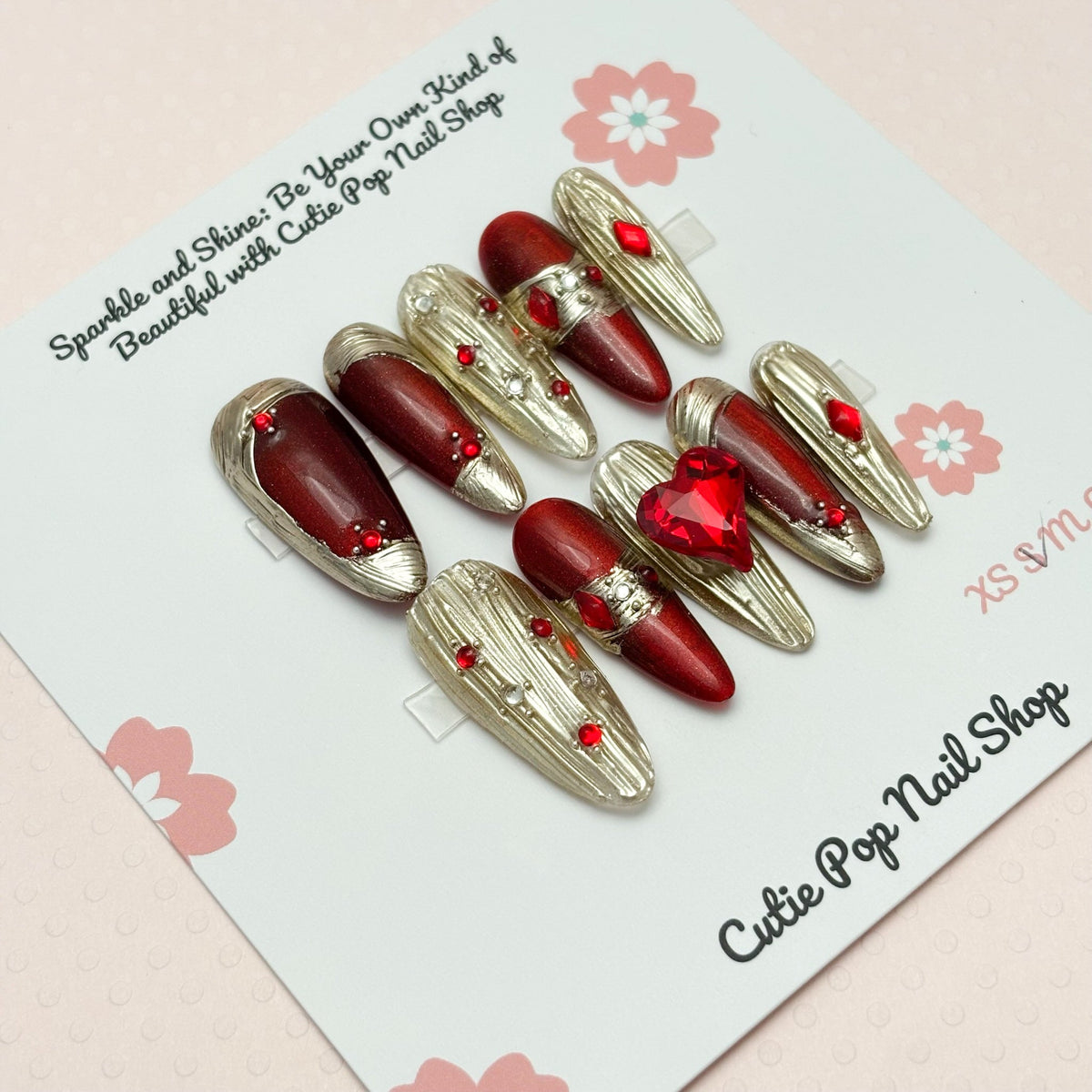 Long red gold press-on nails from Cutie Pop Nail Shop&