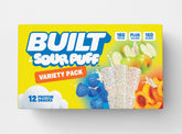 Assorted BUILT Sour Puffs variety box with 12 colorful sour puff candies stacked in a carton.