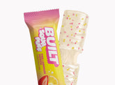BUILT Pink Lemonade Sour Puff candy stacked in a grid, showing bright pink color and soft, puffy texture.
