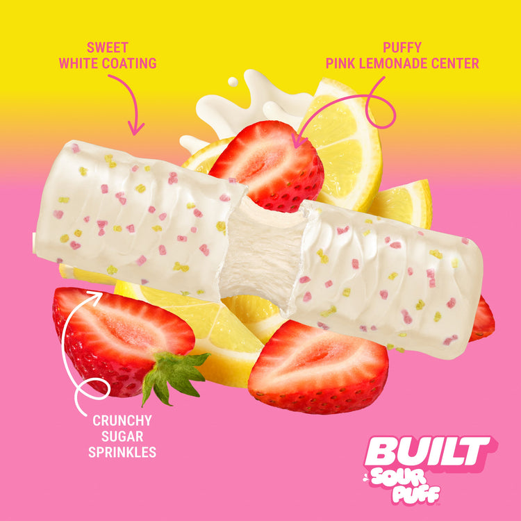 Built Pink Lemonade Squeeze sour puff candy stacked with pink and yellow textures, showing a colorful, fruity snack.