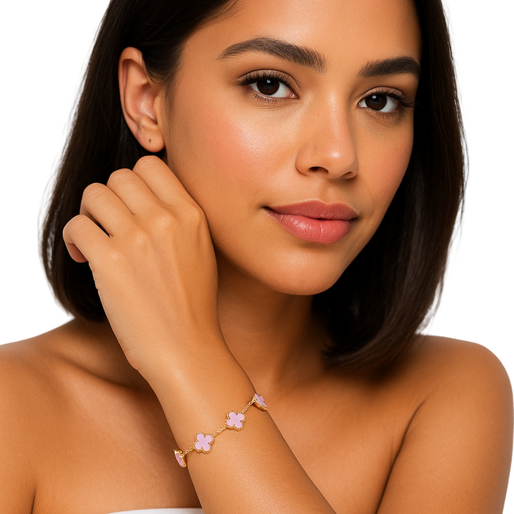 Pink clover enamel bracelet with gold accents from Farmacias Savia jewelry collection, featuring a delicate floral design.