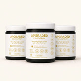 Upgraded Formulas® upgraded colostrum supplement in a jar, showing the product label and white powder inside.