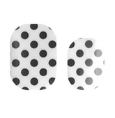 Close-up of Cutie Pop Nail Shop Dots or Spots nail strips with black and white dotted pattern on a neutral background.