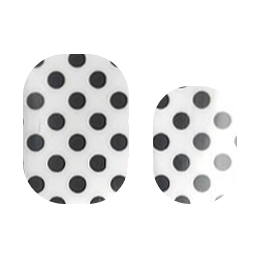 Close-up of Cutie Pop Nail Shop Dots or Spots nail strips with black and white dotted pattern on a neutral background.