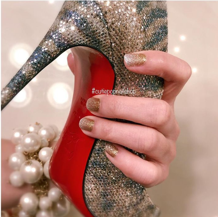 Gold and silver ombre nail strips from Cutie Pop Nail Shop, showcasing a stylish gradient design for elegant manicures.