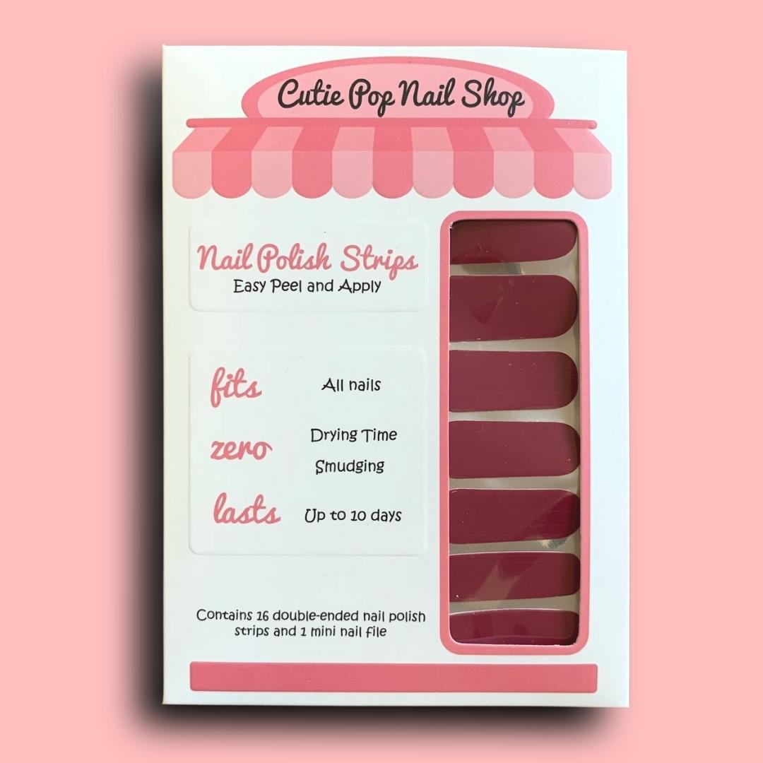 Magenta Magic nail strips by Cutie Pop Nail Shop showcasing vibrant magenta-colored nail art strips.
